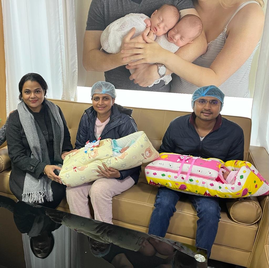 Parents holding their newborn twins at the clinic