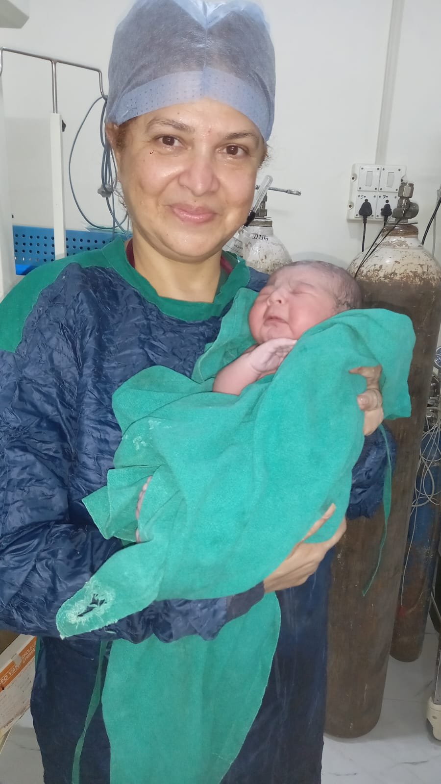 Smiling nurse with a newborn